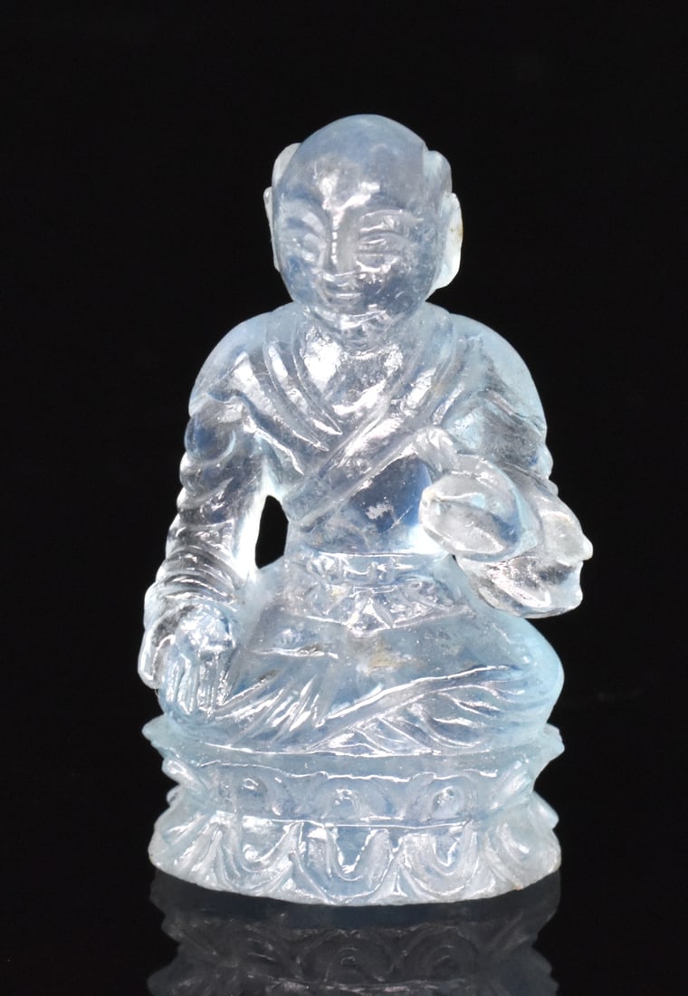 Chinese Aquamarine Carved Luohan,Qing Dynasty: A Chinese aquamarine carved Luohan, dating from the Qing dynasty. Small carved figure on lotus style base with leg crossed and left arm raised in gesture. H. 1 3/8" (3.5 cm) Collection of a private Ro