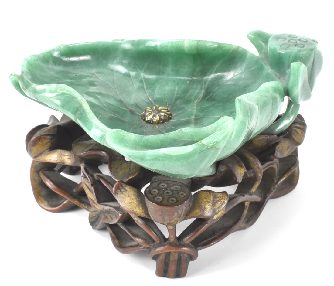 Chinese Spinach Carved Lotus Washer on Stand,Qing: A Chinese spinach carved lotus washer on wooden stand, dating from the Qing dynasty. A triangular shaped concave lotus shaped washer with edges curling inwards, lifelike carving with veins on interior