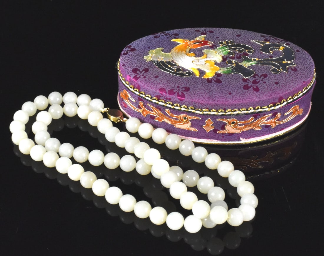 Chinese Jade Carved Necklace, ROC Period: A Chinese jade carved necklace, dating from the Republic period. Comprised of threaded smooth jade balls connected with gold metal clasp. Accompanied by a pretty oval box with pink embroidery interior