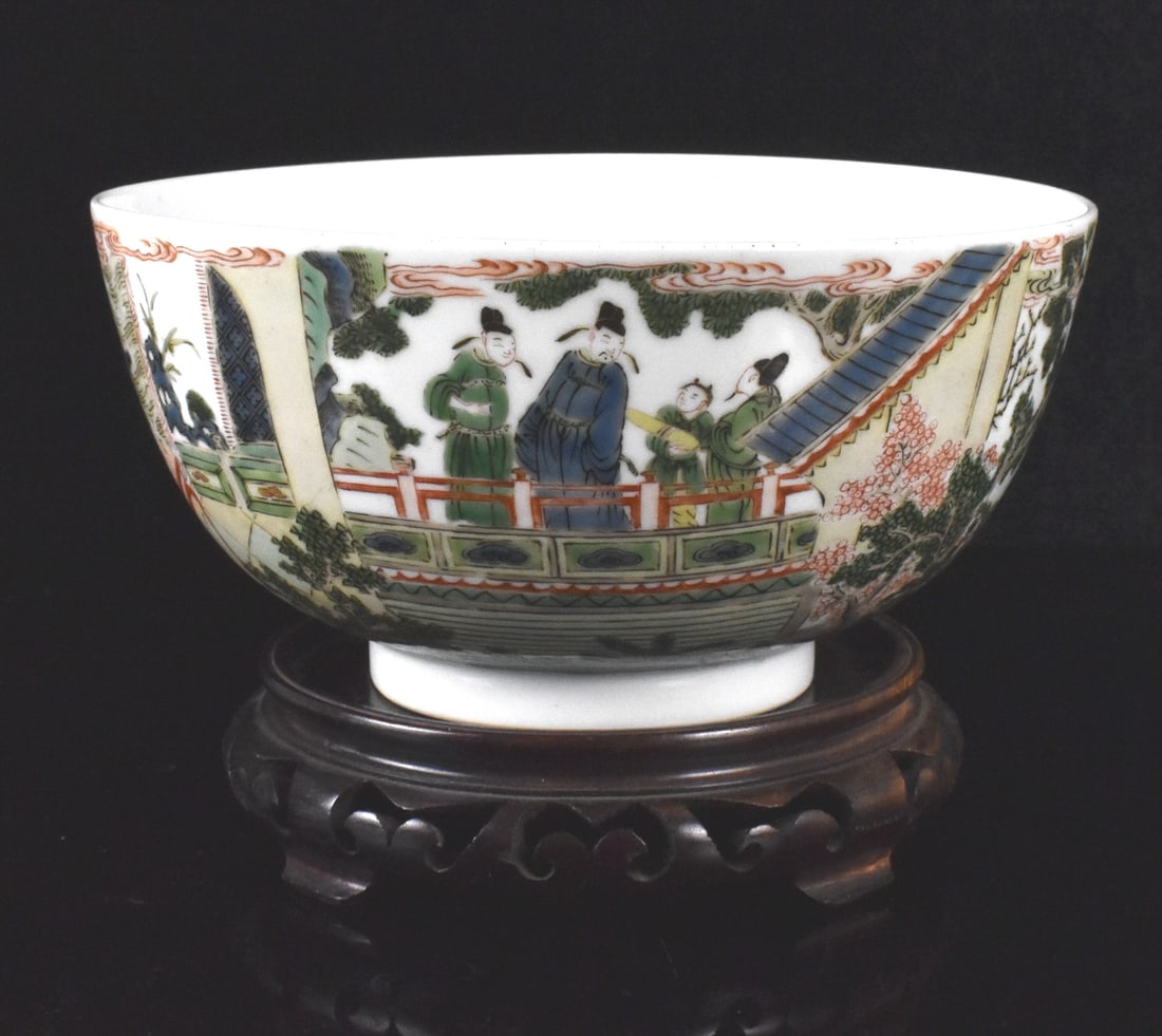 Chinese Wucai Figural Bowl, 18th C.: The deep bowl presents a landscape with small house in center, with elaborate outside wucai decoration of a glimpse into a scene with a scholar with three others, one with a scroll. Vivid green detail