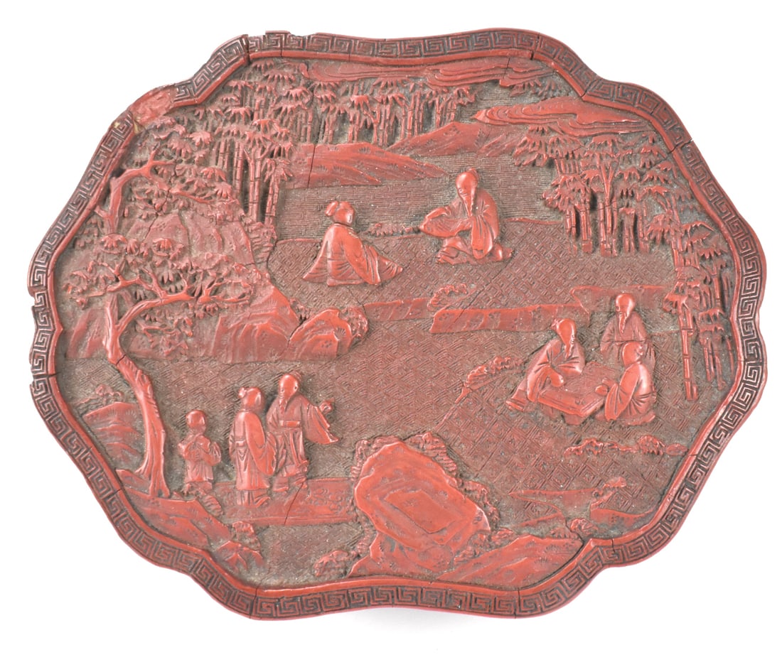 Chinese Cinnabar Lacquered Covered Box,19th C.: A Chinese cinnabar lacquered covered box, dating from the 19th century. Ruyi shaped box carved with seven scholars reading scroll, playing go, chatting in the bamboo forest with rocks ,trees and boy s
