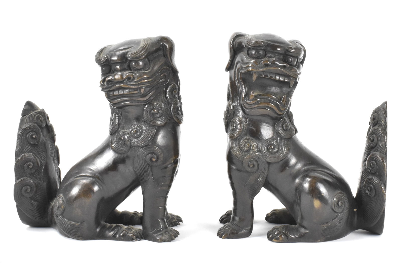 Pair of Chinese Bronze Cast Foo Lion, Qing Dynasty: A pair of Chinese bronze cast foo lions, dating from the Qing dynasty. Heavily cast to serve their purpose of acting as book ends, as their tails are flat and vertical. One faces left, the other right