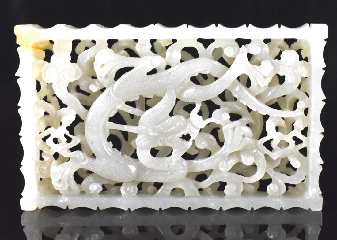 Chinese Reticulated Jade Dragon Plaque, Qing D.: A Chinese reticulated jade dragon plaque. Rectangular plaque with two layers of deep reticulated carving, the top layer with large swirling dragon form amongst scrolling clouds. H. 3" (7.6 cm), W. 1 7