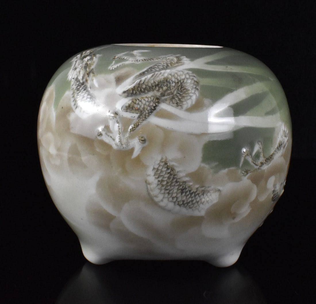 Japanese Studio Porcelain Dragon Censer, Meiji Pe: A Japanese studio porcelain dragon censer, dating from the Meiji period.A circular shape censer with three small angular tripod legs. A raised dragon in clouts wraps around the censer with its head ne