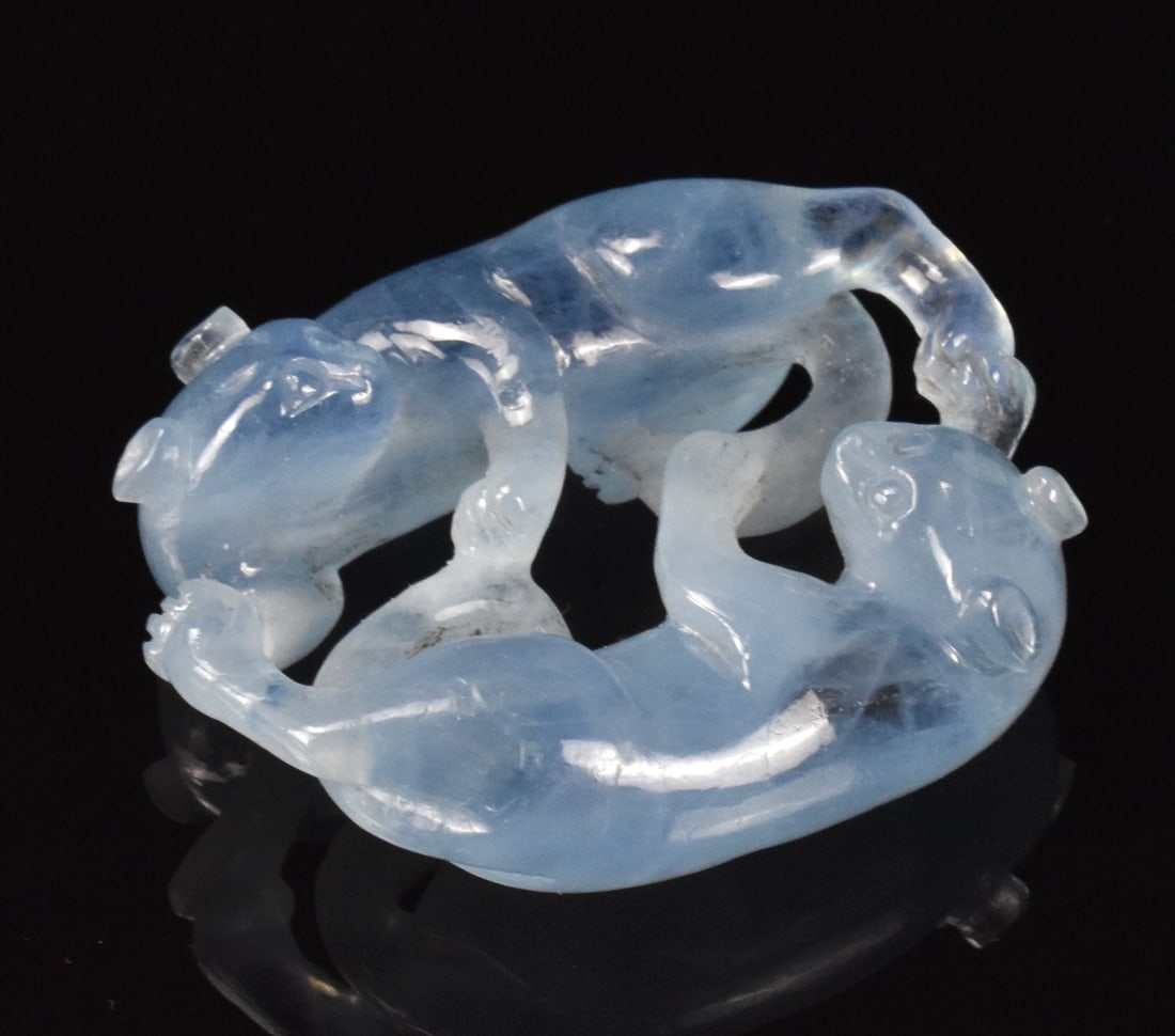 Chinese Aqua Marine Carved Twin Beast Toggle: A Chinese aquamarine carved twin beast toggle. Deeply incised twin beasts connected by their legs and tail facing each other. Smooth aquamarine color throughout. H. 1 5/8" (4.1 cm) Collection of a pri