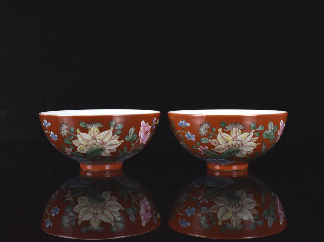 Pair small Chinese Coral Ground Enameled Cups,ROC: A pair of small Chinese ruby ground enameled cups, dating from the Republic period. White glaze sloping interior and dense colorful floral design on exterior against coral ground. Four blue character 