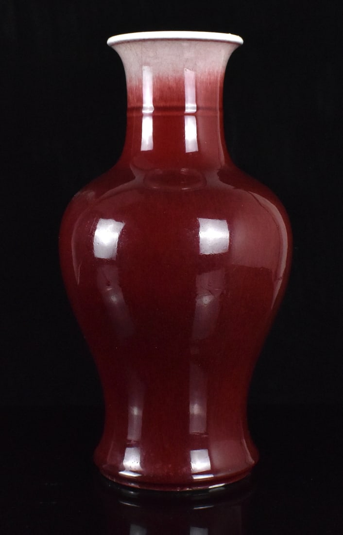 Chinese Langyao Red Glazed Vase,19th C.: A Chinese langyao red glazed vase, dating from the 19th century. Oxblood color vase with wide splayed base and high rounded shoulder, to a short neck and slightly flared rim. White glaze rim transit t