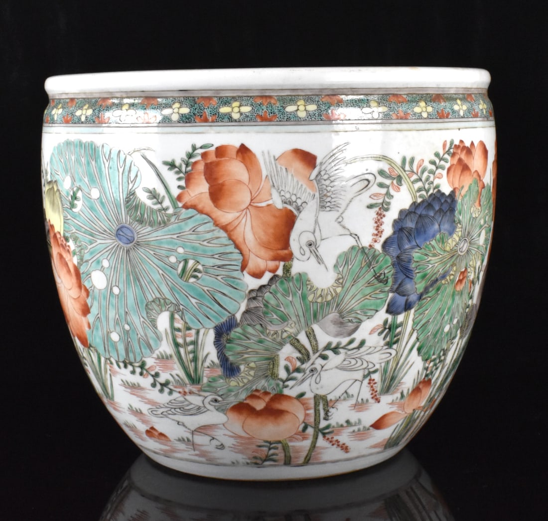 Chinese Famille Verte Jardiniere w/ Lotus, 19th C.: A Chinese famille verte jardiniere with lotus, daiting from the 19th century. A heavily potted jardiniere with wide base expanding to rounded body to a thick lipped rim. Colorful design with different