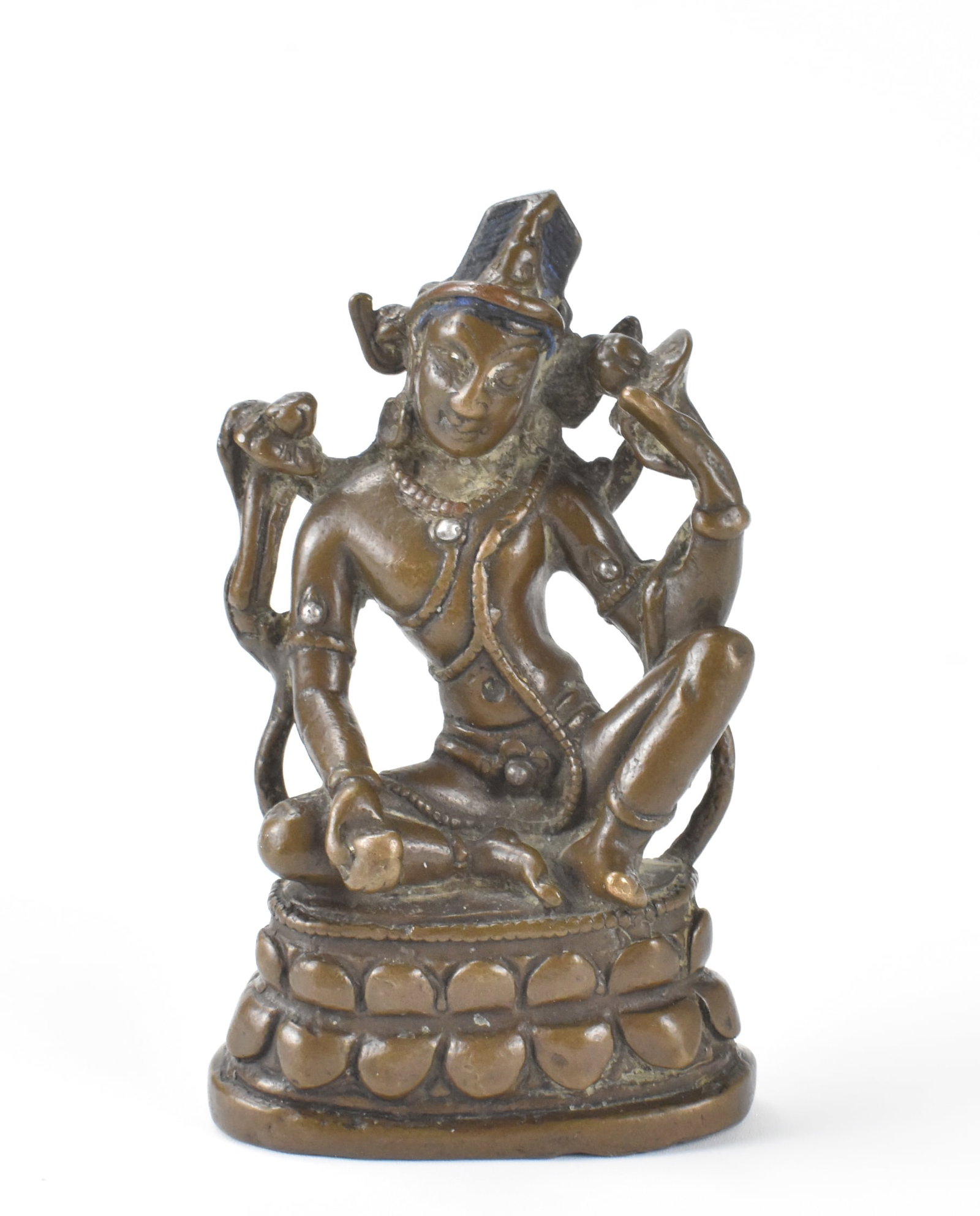 Nepalese Bronze Buddha w/ SIlver Inlay, 15/16th C.: A Nepalese bronze Buddha figure with silver inlay, dating from the 15/16th century. The small and detailed Bronze figure of the Buddha sitting on a lotus platform with left knee up, his left elbow res