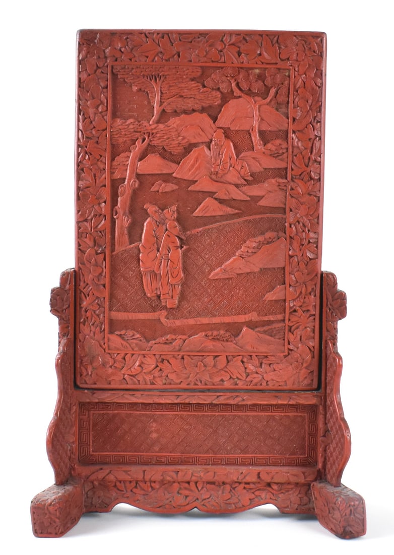 Chinese Cinnabar Carved Lacquer Table Screen,19thC: A Chinese cinnabar carved lacquered table screen, dating from the 19th C. Set on a stand support with slots for the screen on sides, the carved screen features two scholars in nature amongst trees and