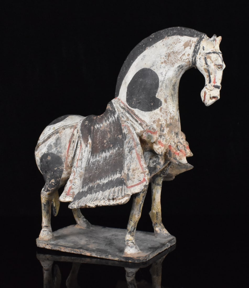Chinese Fine Painted Pottery Horse, Northern Qi D.: A Chinese fine painted pottery horse, dating from the Northern Qi dynasty. Dynamic pottery horse standing tall on all four legs with head curved downwards and the saddle blanket flared out on both sid
