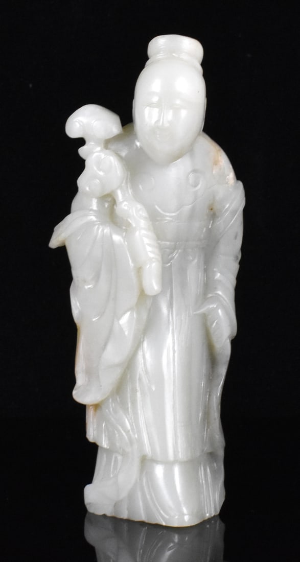 Chinese Jade Carved Figurine, 18th C.: A Chinese jade carved figurine, dating from the 18th century. Carved standing jade figurine holding a Ruyi scepter in right hand and wearing robes. H. 5 1/2" (14 cm) Collection of a private Palm Beach