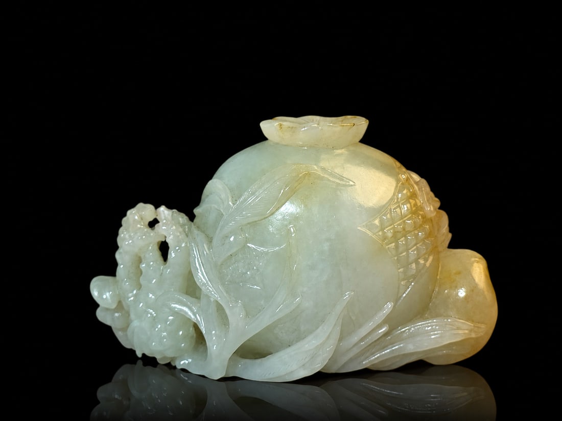 Chinese Carved Jade Boulder w/ Boy & Fruit: Chinese carved jade boulder depicting boy crawling with a large Pomegranate along carved with peach and Buddha hand ( form as "Sanduo") W. 4" (10.1 cm), H. 2.6" (6.6 cm) Collection of a private Chicag