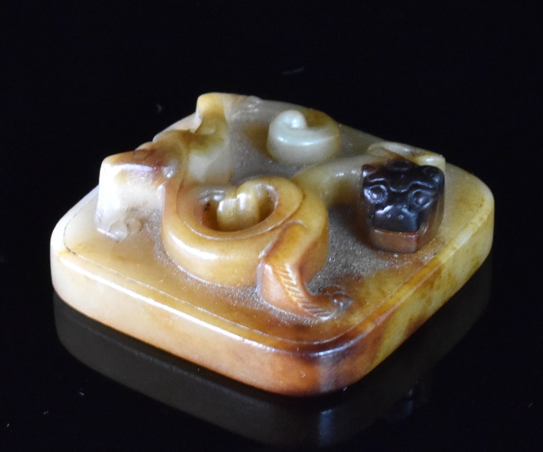 Chinese Jade Carved Squared Seal w/ Dragon: A Chinese jade carved squared seal with dragon motif. dated from Ming Dynasty Squared seal with central hole and rounded corners. carved on top is chi dragon curving around all four sides and lightly 