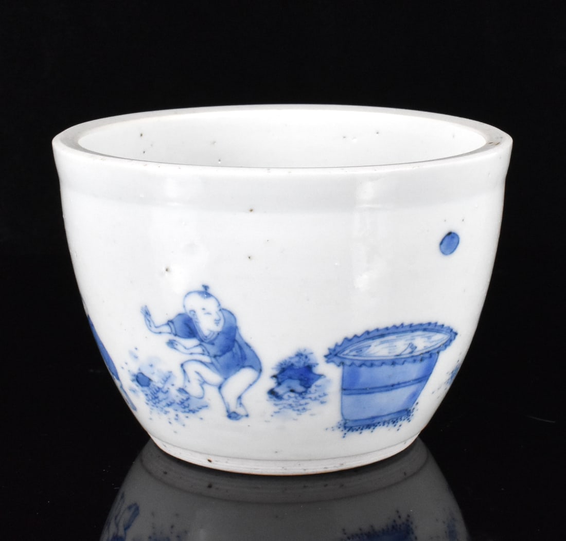 Small Chinese Blue & White Jardiniere,Qing Dynasty: A small Chinese blue and white jardiniere, dating from the 17th century. The small, thick jardiniere has white glazed interior and a blue scene around exterior of boys frolicking in nature. With an un