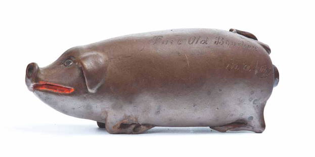 ANNA POTTERY PIG FLASK: Wallace and Cornwall Kirkpatrick, Anna, IL, 3rd quarter-19th century. Brown-glazed stoneware, of typical form, with early/original red paint on the lips and genitals, and inscription "Pure Old Bourbon