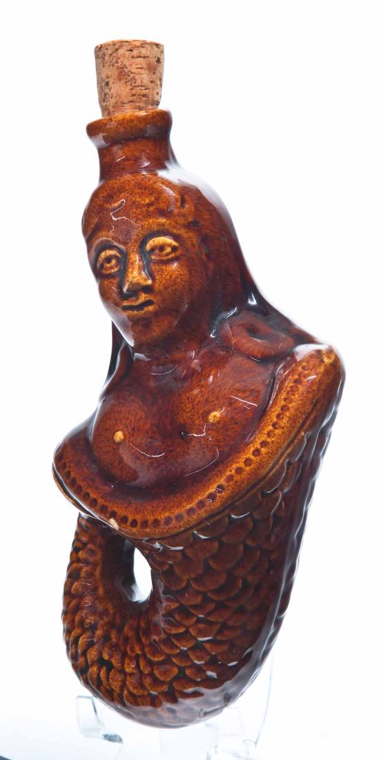 FIGURAL MERMAID FLASK: American or English, 19th century. With a Rockingham-type glaze. 8" long.