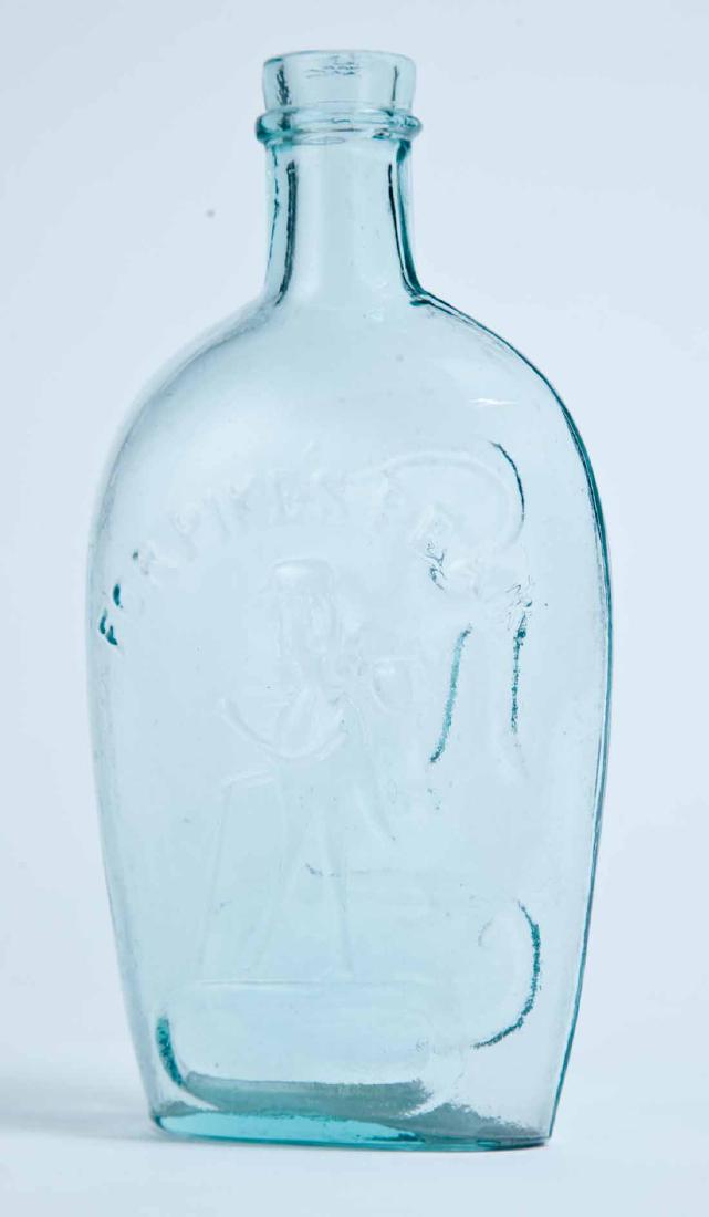 "FOR PIKE'S PEAK" & EAGLE FLASK: GXI-21, American, mid-19th century, pint, aqua in color, with big-headed prospector on the obverse and an eagle on the reverse, ringed lip, and plain base. 7.75" high.