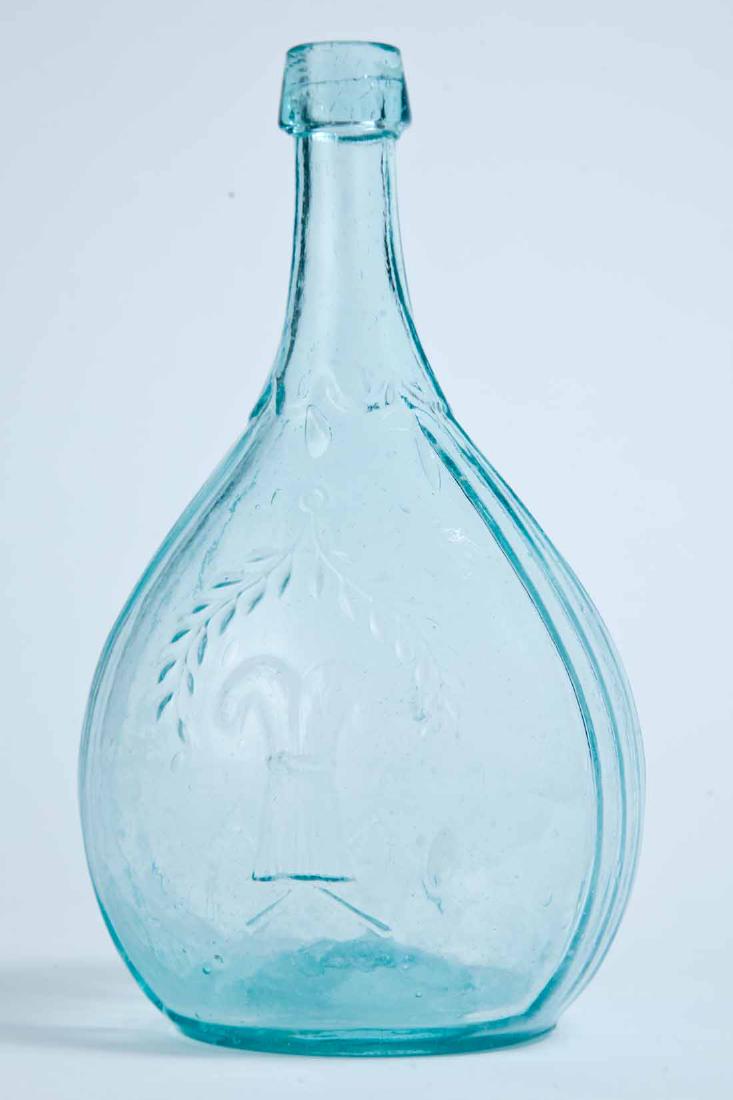 SHEAF OF WHEAT & STAR CALABASH FLASK: GXIII-43, Sheets and Duffy, mid-19th century, quart, aqua in color, with a sheaf of wheat and laurel branch on the obverse and a star under a blank banner on the reverse, and a pontil mark. 9" high.
