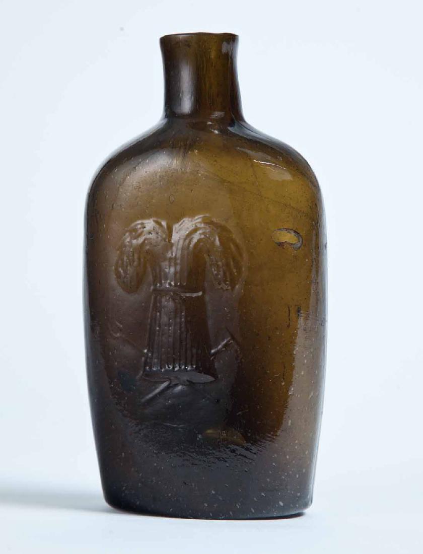 CONNECTICUT SHEAF OF WHEAT FLASK: GXIII-35, Westford Glass Co., Westford, CT, mid-19th century, half pint, olive-amber in color, with a sheaf of wheat on the obverse, and "WESTFORD GLASS CO. WESTFORD CONN" on the reverse, plain lip, a