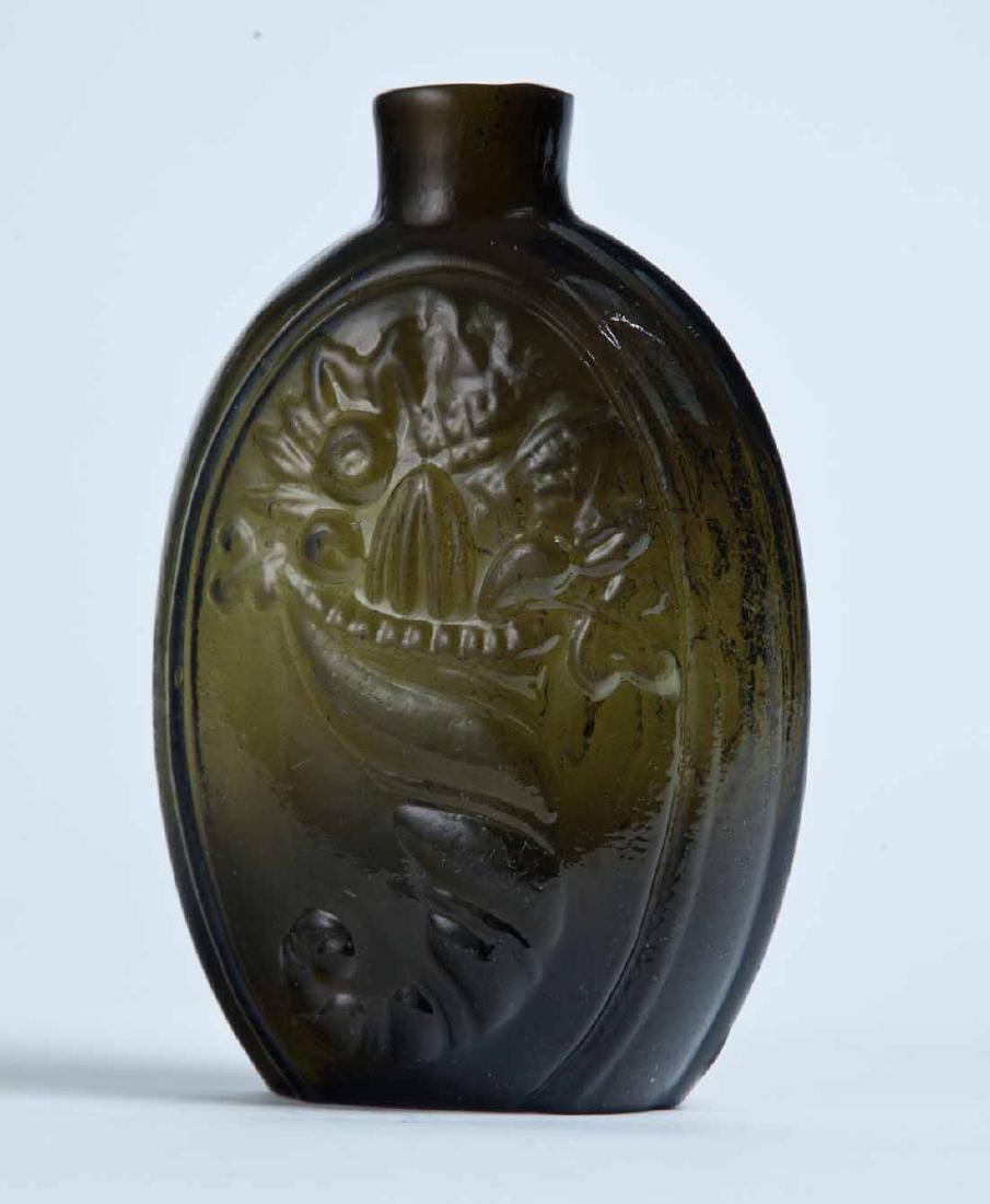 CORNUCOPIA FLASK: GIII-7, Keene or Coventry, mid-19th century, half pint, deep olive in color, with a cornucopia on the obverse and an urn on the reverse, and a plain lip and pontil mark. 5.25" high.