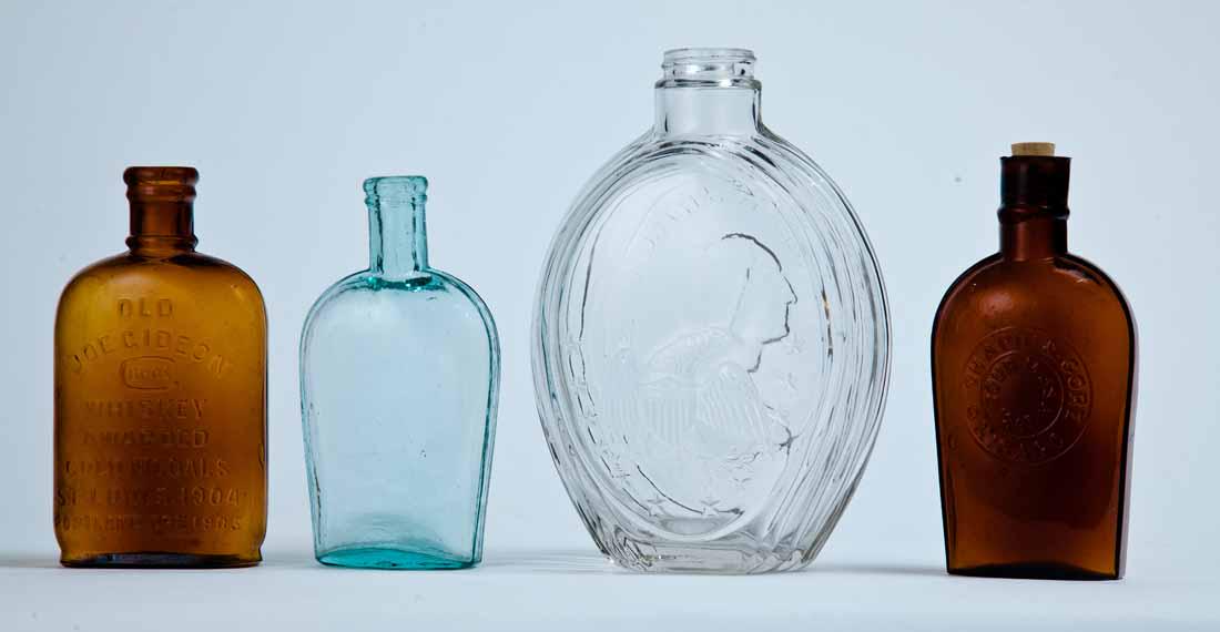 4 MOLDED FLASKS: American, late 19th-early 20th century. Includes an amber flask for "OLD JOE GIDEON BROS. WHISKEYâ€¦PORTLAND ORE.," 6" high; an amber "CHAPIN & GOREâ€¦CHICAGO" flask, 6.125" high; a plain aqua