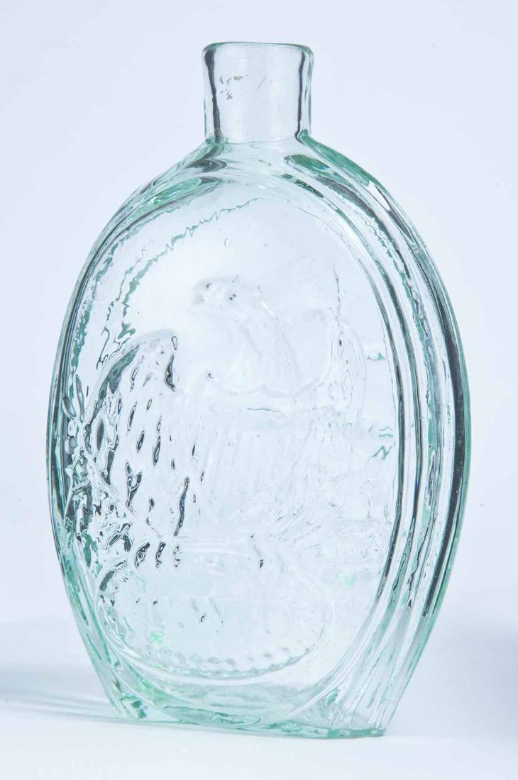 EAGLE & SHIP FRANKLIN FLASK: GII-42, Kensington Glass Works, Philadelphia, mid-19th century, pint, aqua in color, with an eagle and "T.W.D." on the obverse and a ship and "FRANKLIN" on the reverse, and a plain lip and pontil mark