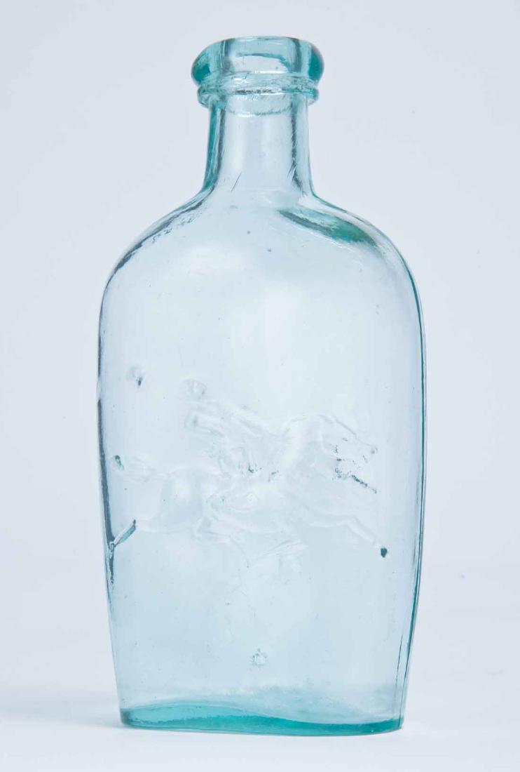 HORSEMAND & HOUND FLASK: GXIII-18, American, mid-19th century, half pint, aqua in color, with a horseman whose hat has flown off on the obverse and a hound on the reverse, tooled lip and plain bottom. 6" high.