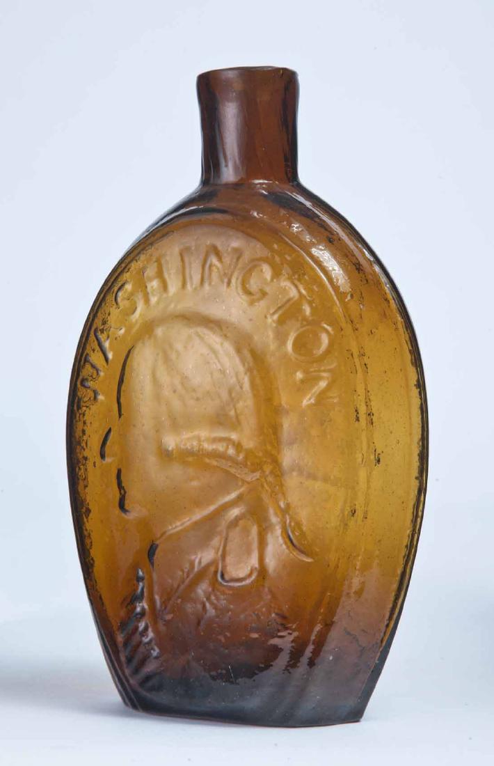 WASHINGTON & JACKSON FLASK: GI-31, Keene-Marlboro-Street Glass Works, Keene, NH, mid-19th century, pint, amber in color, with left-facing portraits of Washington and Jackson with their names arched overtop, plain lip and pontil 