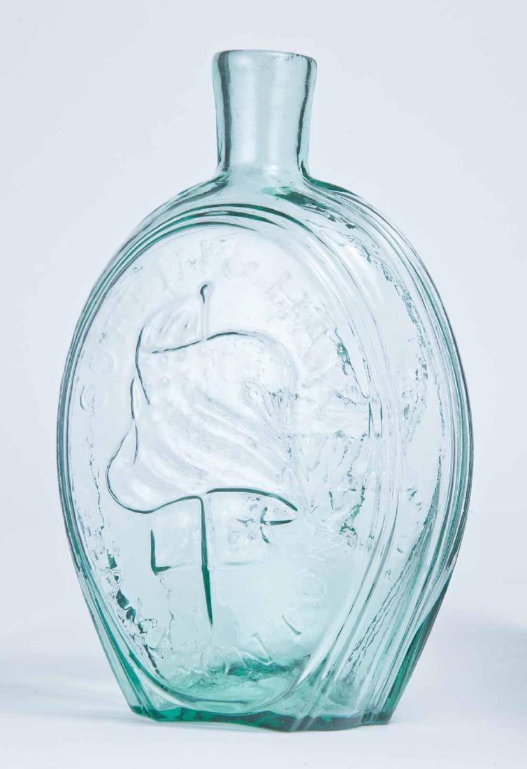 "COFFIN & HAY" EAGLE FLASK: GII-48, Coffin and Hay, Hammonton, NJ, mid-19th century, quart, aqua in color, with a rayed eagle on the obverse and a furled flag with "COFFIN & HAY HAMMONTON" on the reverse, plain lip and pontil ma