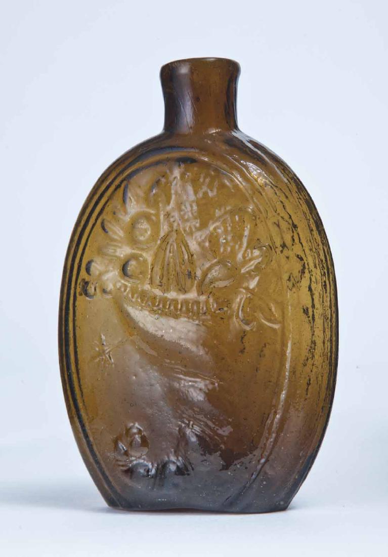 CORNUCOPIA FLASK: GIII-11, Saratoga or Mt. Vernon, NY, mid-19th century, half pint, amber in color, with a cornucopia with extended leaf on the obverse and an urn on the reverse, plain lip and broken pontil. 5.5" high.