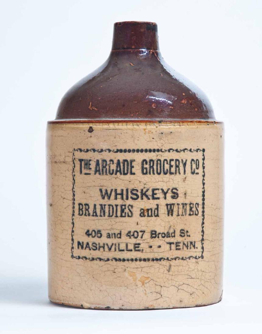 NASHVILLE, TENNESSEE ADVERTISING STONEWARE WHISKEY JUG: 1-gallon jug with bicolor glaze and stenciled advertisement "THE ARCADE GROCERY CO WHISKEYS BRANDIES and WINES 405 and 407 Broad St. NASHVILLE -- TENN." 11" high.