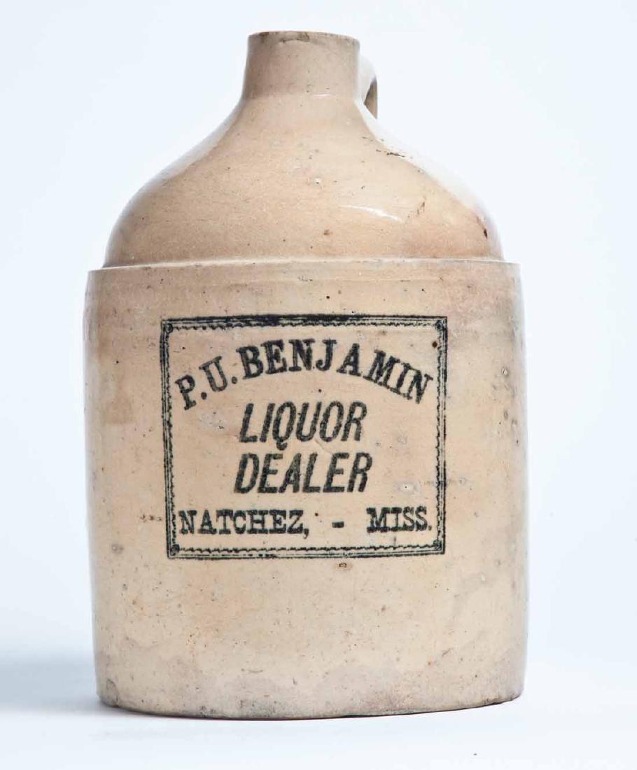 NATCHEZ, MISSISSIPPI ADVERTISING STONEWARE LIQUOR JUG: 1-gallon jug with stenciled advertisement "P.U. BENJAMIN LIQUOR DEALER NATCHEZ, -MISS." 10.75" high.