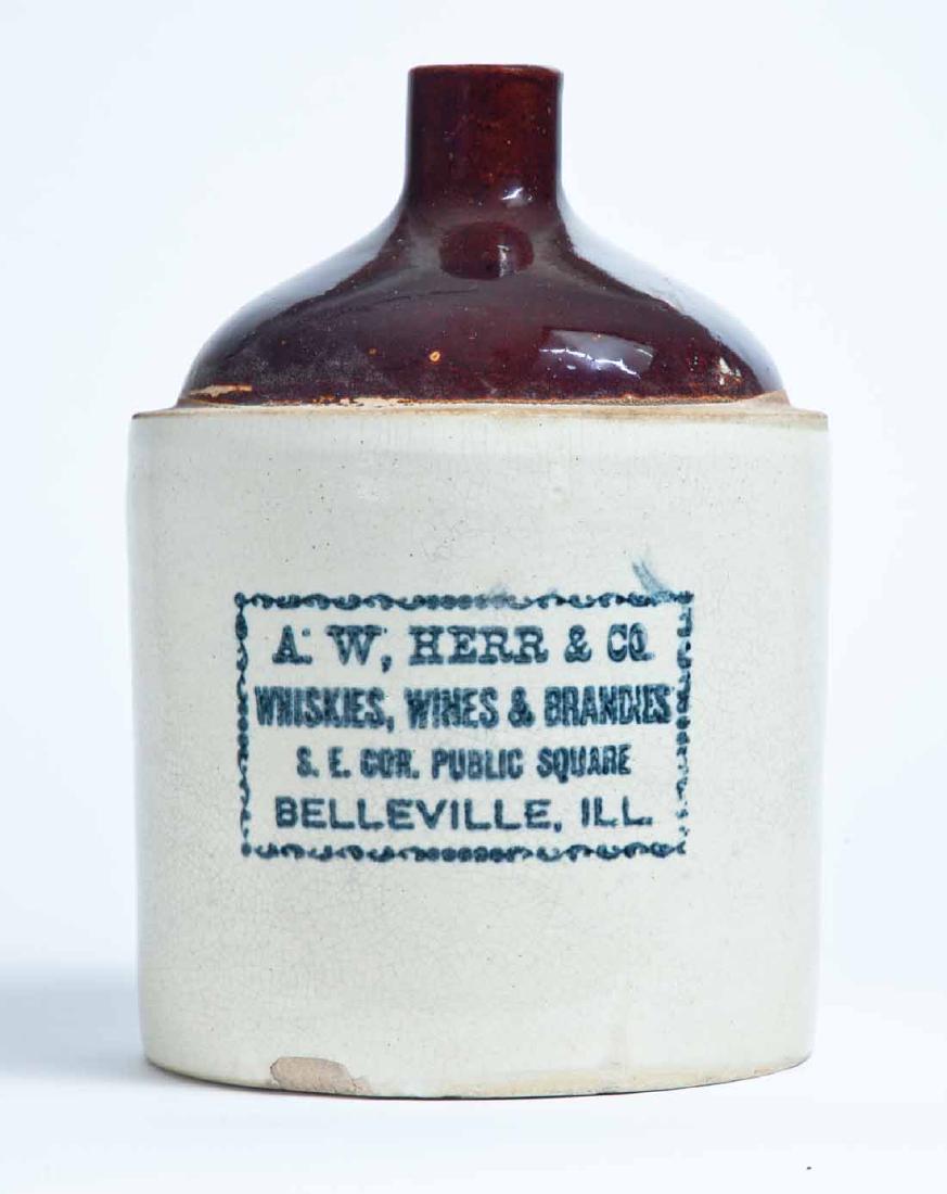 BELLEVILLE, ILLINOIS ADVERTISING STONEWARE LIQUOR JUG: 1-gallon jug with bicolor glaze and stamped advertisement "A.W. HERR & CO. WHISKIES, WINES & BRANDIES S.E. COR. PUBLIC SQUARE BELLEVILLE, ILL." 10.25" high.