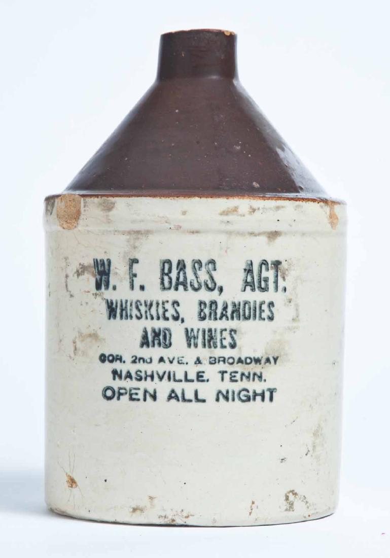 NASHVILLE, TENNESSEE ADVERTISING STONEWARE LIQUOR JUG: Half-gallon jug with bicolor glaze and stamped advertisement "W.F. BASS, AGT. WHISKIES, BRANDIES AND WINES COR. 2nd & BROADWAY NASHVILLE, TENN. OPEN ALL NIGHT. 9" high.