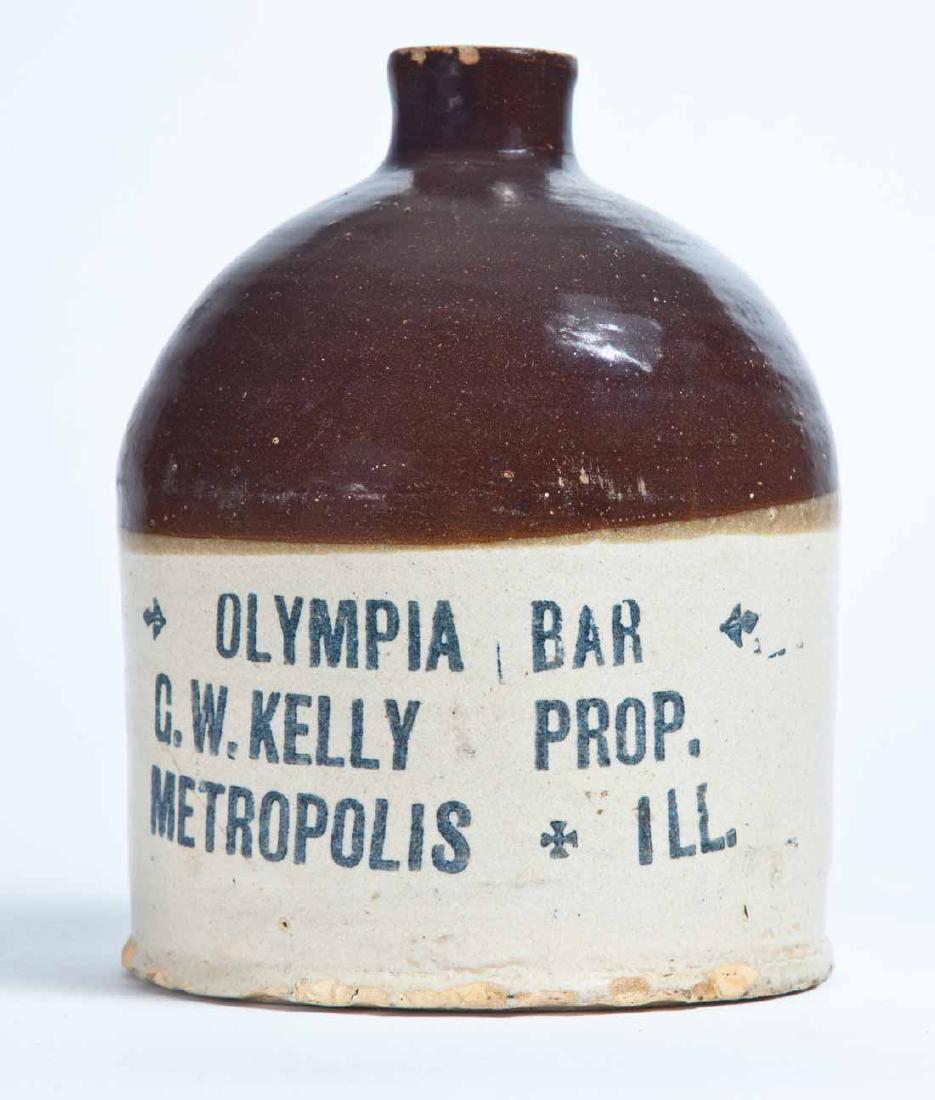 METROPOLIS, ILLINOIS ADVERTISING STONEWARE LIQUOR JUG: Half-gallon jug with bicolor glaze and stamped advertisement "OLYMPIA BAR G.W. KELLY PROP. METROPOLIS, ILL." 8" high.