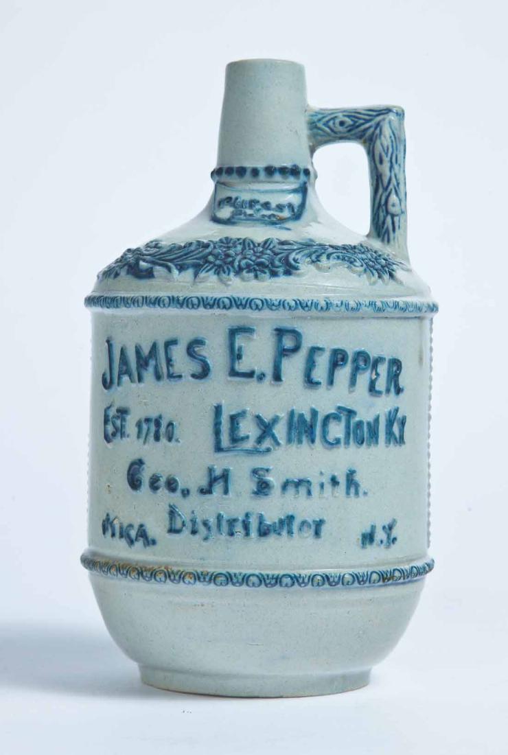 LEXINGTON, KENTUCKY ADVERTISING STONEWARE LIQUOR JUG: White's, Utica, small molded jug with molded and cobalt-accented advertisement "JAMES E. PEPPER EST. 1780 LEXINGTON KY GEO. H. SMITH DISTRIBUTOR UTICA, NY." 7.75" high.