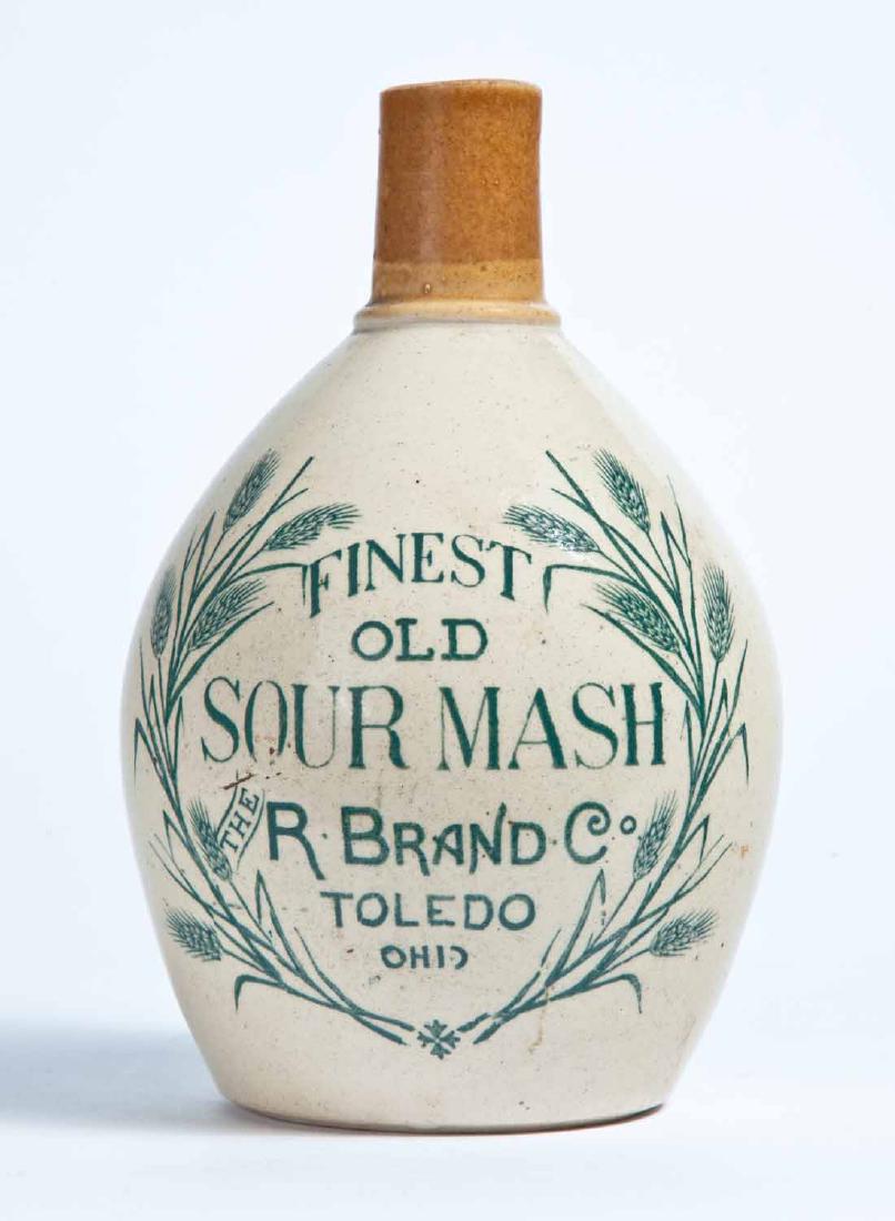 TOLEDO, OHIO ADVERTISING STONEWARE LIQUOR JUG: Small size, with a bicolor glaze and stamped advertisement "FINEST OLD SOUR MASH THE R. BRAND CO. TOLEDO OHIO." 7.5" high.