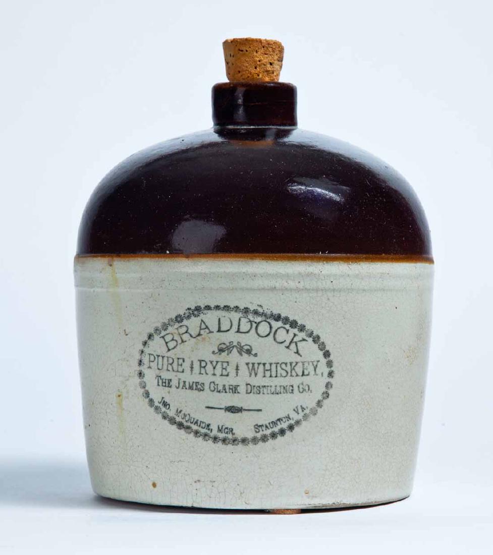 STAUNTON, VIRGINIA ADVERTISING STONEWARE WHISKEY JUG: Half-gallon jug with bicolor glaze and stamped advertisement "BRADDOCK PURE RYE WHISKEY THE JAMES CLARK DISTILLING CO. JNO. MCQUAIDE, MGR. STAUNTON, VA." 7" high.