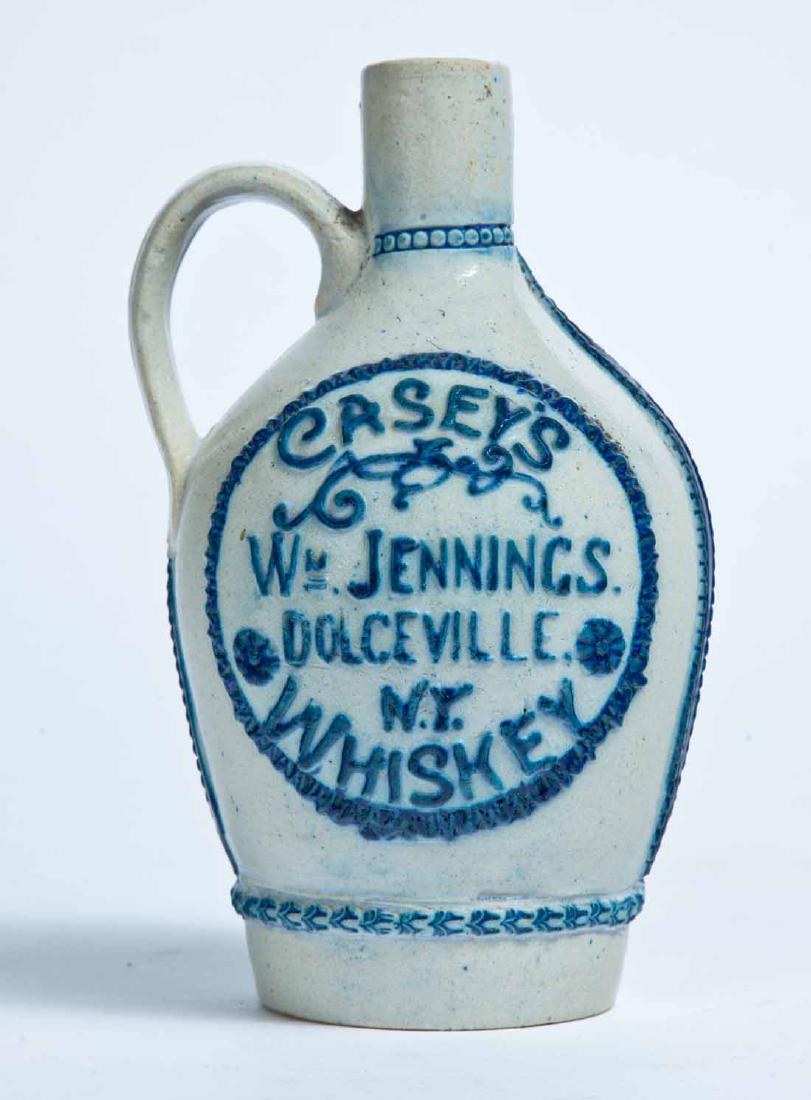 DOLCEVILLE, NY ADVERTISING MOLDED STONEWARE JUG: White's, Utica, small size, molded and cobalt-highlighted advertisement "CASEY'S WHISKEY WM. JENNINGS DOCLEVILLE, N.Y." 6.5" high.