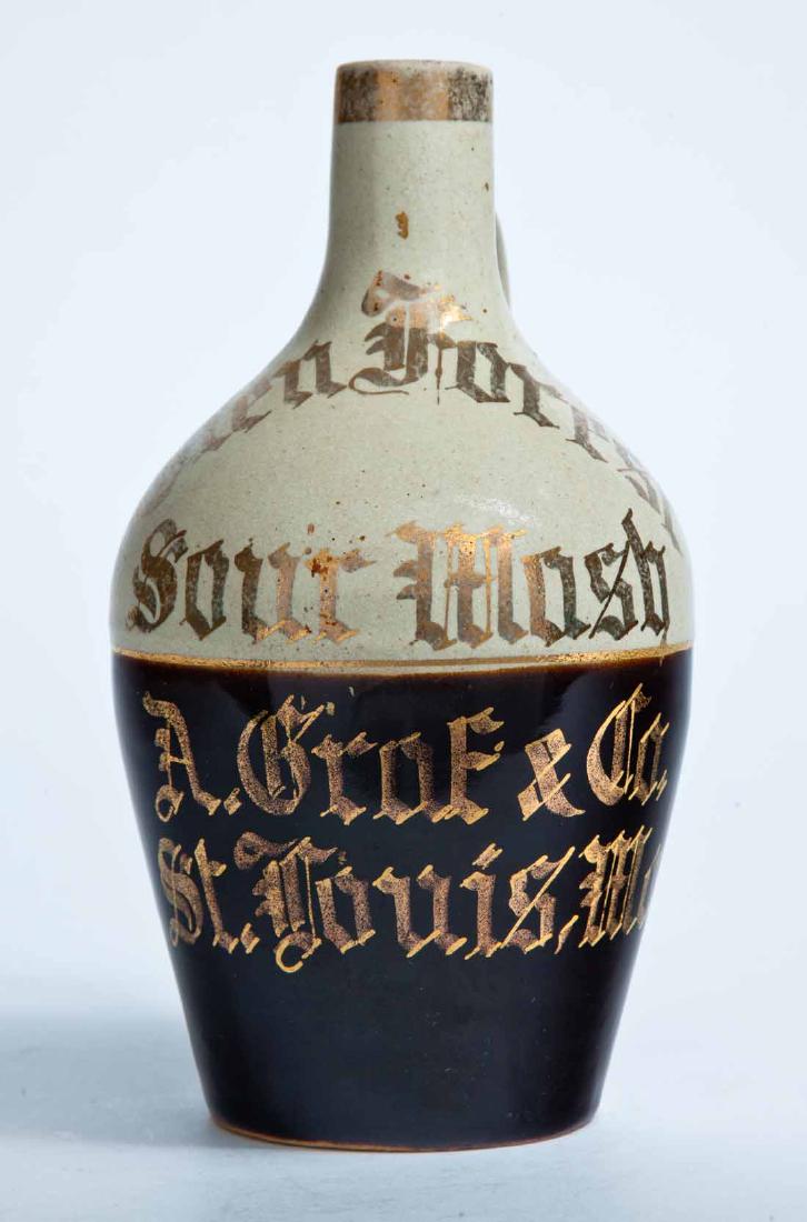 ST LOUIS, MISSOURI ADVERTISING STONEWARE WHISKEY JUG: Smalle size jug with bicolor glaze and gilt-stamped advertisement "Glen Forest Sour Mash A. Grof & Co. St. Louis, Mo." in a Germanic script. 8.25" high.