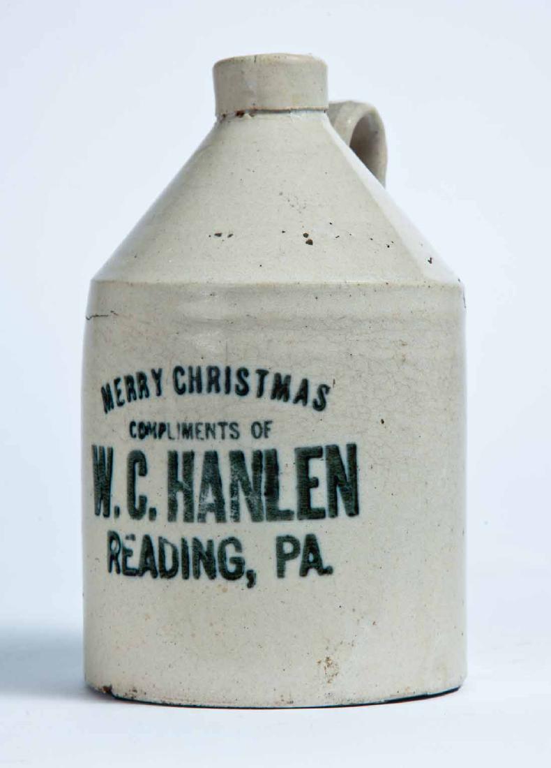 READING, PENNSYLVANIA ADVERTISING STONEWARE LIQUOR JUG: Small size jug with stamped advertisement "MERRY CHRISTMAS COMPLIMENTS OF W.C. HANLEN READING, PA." 7.25" high.