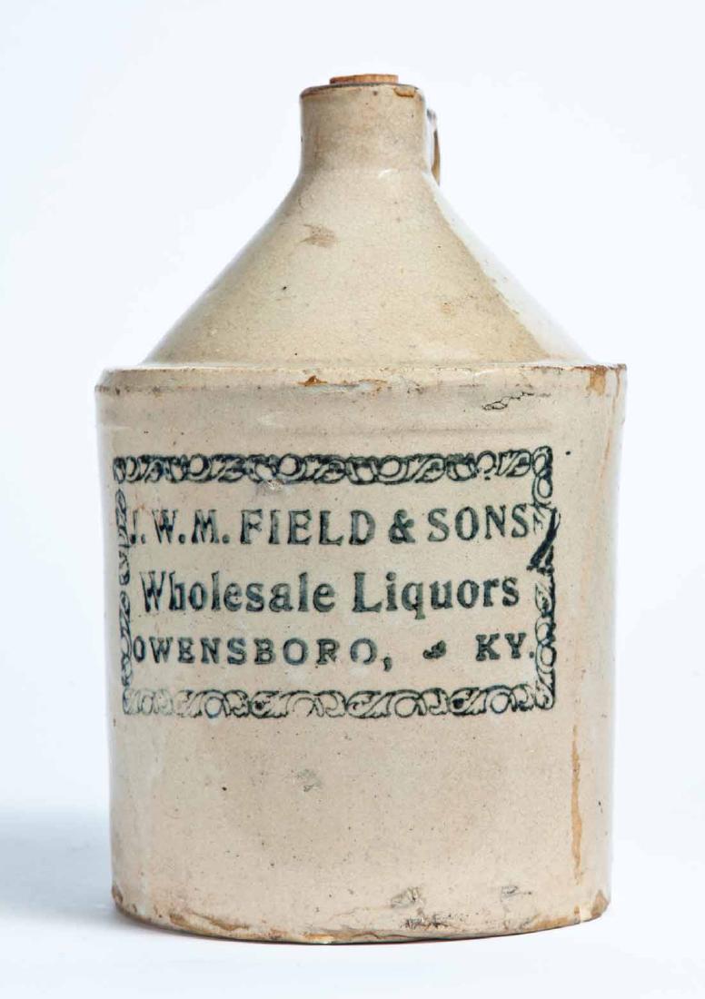 O W ENSBORO, KENTUCKY ADVERTISING STONEWARE LIQUOR JUG: Half-gallon jug with stamped advertisement "J.W.M. FIELD & SONS Wholesale Liquors OWENSBORO, KY." 9" high.