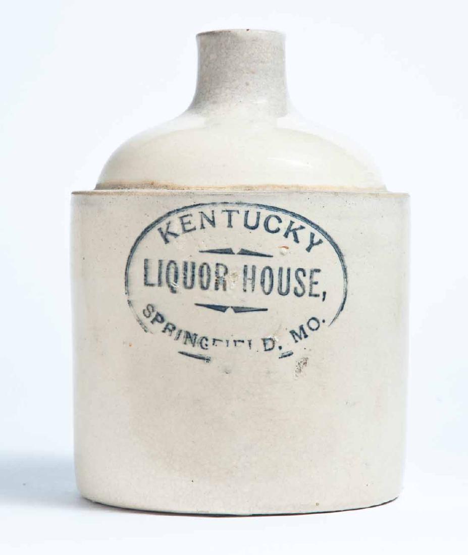SPRINGFIELD, MISSOURI ADVERTISING STONEWARE LIQUOR JUG: Macomb Stoneware Co., Macomb, IL, half-gallon jug with stamped advertisement "KENTUCKY LIQUOR HOUSE, SPRINGFIELD, MO." 8" high.