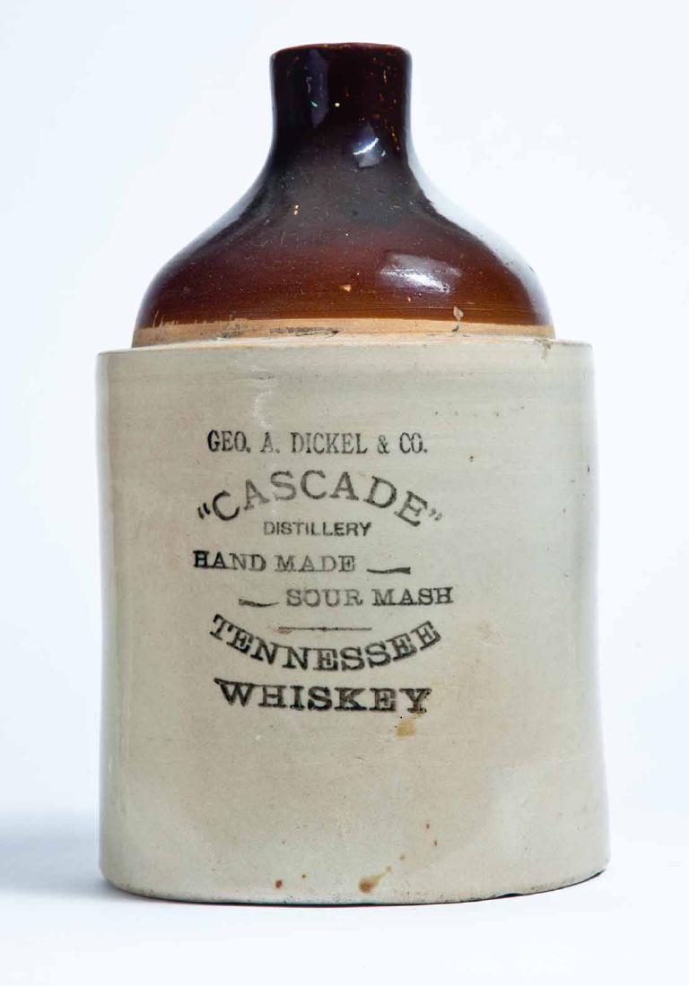TENNESSEE ADVERTISING STONEWARE WHISKEY JUG: 1-gallon jug with bicolor glaze and stamped advertisement "GEO. A. DICKEL & CO. "CASCADE" DISTILLERY HAND MADE SOUR MASH TENNESSEE WHISKEY." 11.25" high.