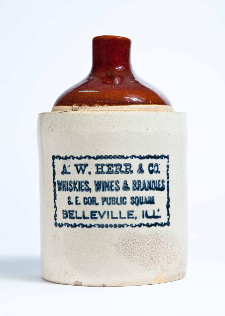 BELLEVILLE, ILLINOIS ADVERTISING STONEWARE LIQUOR JUG: Half-gallon jug with bicolor glaze and stamped advertisement "A.W. HERR & CO. WHISKIES, WINES & BRANDIES S.E. COR. PUBLIC SQUARE BELLEVILLE, ILL." 9" high.