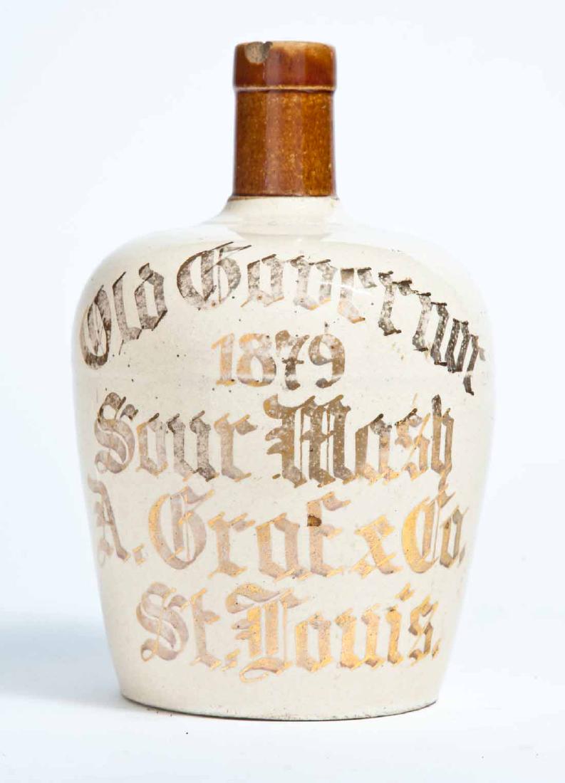 ST LOUIS, MISSOURI ADVERTISING STONEWARE WHISKEY JUG: Small-size jug with bicolor glaze and gilt-stamped advertisement "Old Governor 1879 Sour Mash A. Grof & Co. St. Louis." in a Germanic script. 7.5" high.