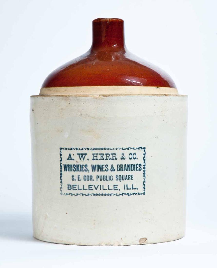 BELLEVILLE, ILLINOIS ADVERTISING STONEWARE LIQUOR JUG: 2-gallon jug with bicolor glaze and stamped advertisement "A.W. HERR & CO. WHISKIES, WINES & BRANDIES S.E. COR. PUBLIC SQUARE BELLEVILLE, ILL." 12" high.