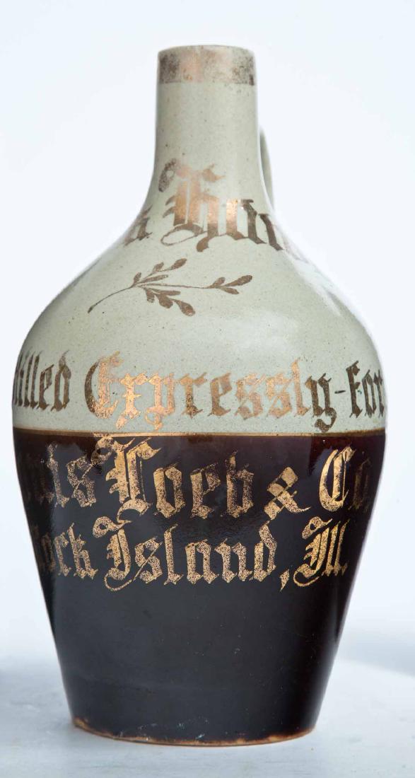 ROCK ISLAND, ILLINOIS ADVERTISING STONEWARE RYE JUG: Small-size jug with bicolor glaze and gilt-stamped advertisement "Black Hawk Rye Distilled Expressly for Louis Loeb & Co. Rock Ilsand, Ill." in a Germanic script. 8.5" high.