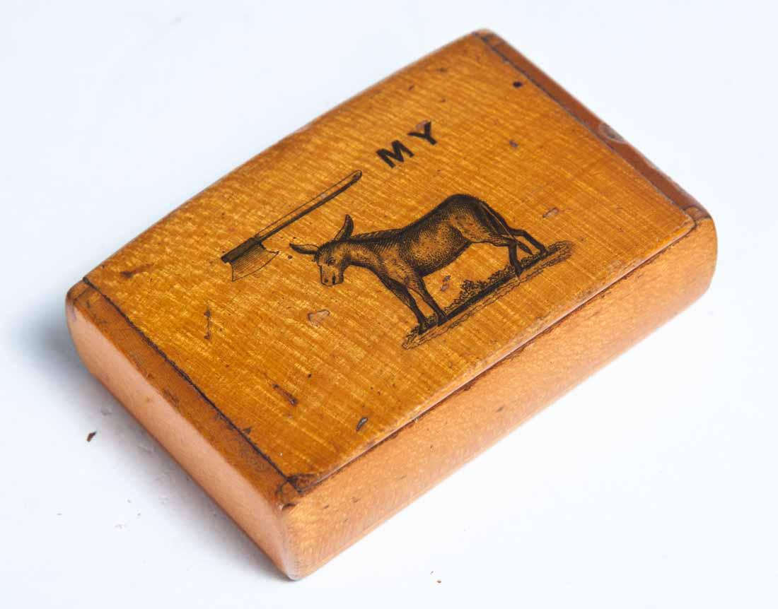 SMALL POLITICAL SNUFF BOX: Rectangular maple box with hinged lid and transfer decoration of an axe "MY" and a mule. .5"h. 2.25"l. 1.5"w.